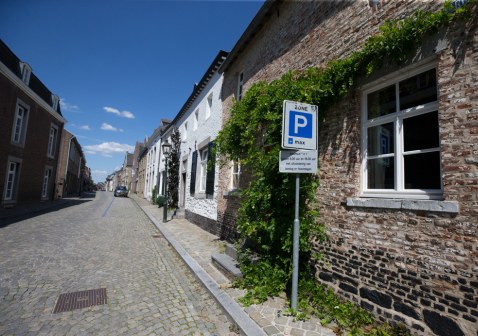 Straat in oude kern Eijsden met bord dat blauwe zone aangeeft. 